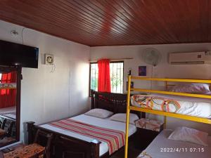 a room with two bunk beds and a flat screen tv at Casa Eguis in Gaira