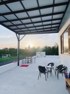 a group of chairs and tables on a patio at 漫活時光民宿 Leisure Living in Baisha