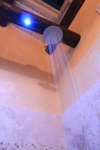 a shower head hanging from the ceiling of a bathroom at La Casa della Peggiola - Le Case Antiche in Verucchio