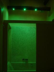 a green light in a bathroom with a shower at La Casa della Peggiola - Le Case Antiche in Verucchio