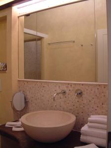 a bathroom with a large sink and a mirror at La Casa della Peggiola - Le Case Antiche in Verucchio