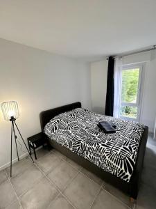 a black and white bed in a room with a window at !NEW! Disney/Paris - 50m RER A in Noisy-le-Grand