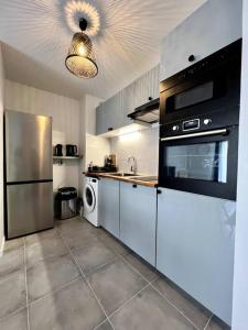 a kitchen with stainless steel appliances at !NEW! Disney/Paris - 50m RER A in Noisy-le-Grand