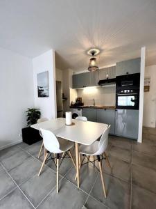 a kitchen with a table and chairs in a room at !NEW! Disney/Paris - 50m RER A in Noisy-le-Grand