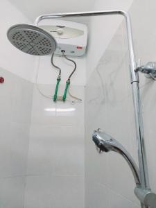 a shower in a bathroom with a shower head at Da Tree Homestay in Hanoi
