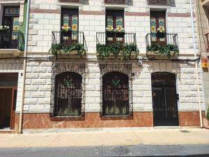 a building with flower boxes on the front of it at Apartamento Merlot 11 in Novelda +5 photos