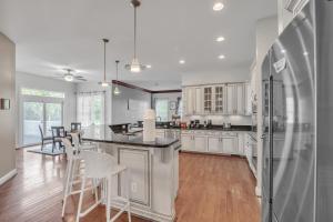 a kitchen with white cabinets and a table and chairs at Bull Run Estate- Luxury Retreat with Scenic Views home in Haymarket