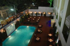 an overhead view of a swimming pool at night at Sandesh The Prince in Mysore