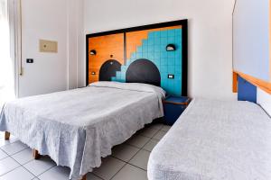 Postel nebo postele na pokoji v ubytování Hotel Rondinella