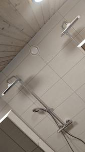 a shower in a bathroom with two lights on the ceiling at Chalupa Sedmidvory in Vernířovice