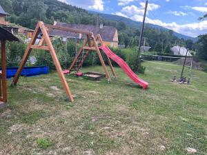 a playground with a slide in a yard at Chalupa Sedmidvory in Vernířovice
