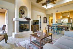 a living room with a couch and a fireplace at Inviting Las Cruces Condo Less Than 1 Mi to Mesilla Plaza! in Las Cruces