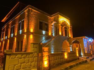 a building with lights on it at night at Rustic Caves Hotel in Göreme