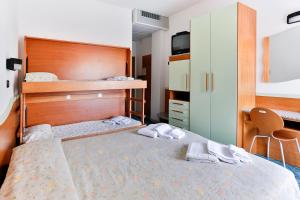 Postel nebo postele na pokoji v ubytování Hotel Rondinella