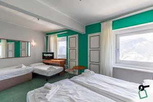 Postel nebo postele na pokoji v ubytování HOTIDAY Room Collection - Sauze Torre