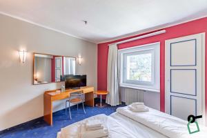 Postel nebo postele na pokoji v ubytování HOTIDAY Room Collection - Sauze Torre