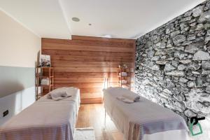 Postel nebo postele na pokoji v ubytování HOTIDAY Room Collection - Sauze Torre