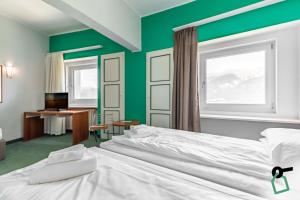 Postel nebo postele na pokoji v ubytování HOTIDAY Room Collection - Sauze Torre