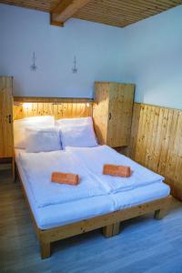 a bedroom with a large bed with two pillows on it at Chalupa Sedmidvory in Vernířovice