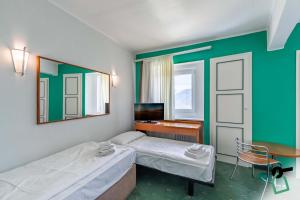 Postel nebo postele na pokoji v ubytování HOTIDAY Room Collection - Sauze Torre