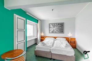 Postel nebo postele na pokoji v ubytování HOTIDAY Room Collection - Sauze Torre