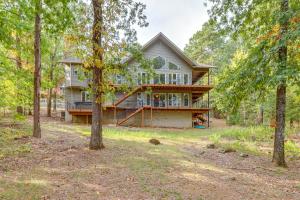 a house in the woods with trees at Fairfield Bay Retreat with Fireplaces and Lake Access in Fairfield Bay