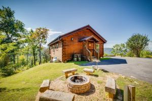 a log cabin with a fire pit in front of it at Ever After Mountain View Hot Tub Jetted Tub Fire Pit Great Location in Gatlinburg