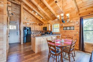 a dining room and kitchen with a table and chairs at Ever After Mountain View Hot Tub Jetted Tub Fire Pit Great Location in Gatlinburg