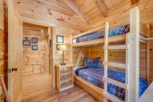 a log cabin bedroom with two bunk beds at Ever After Mountain View Hot Tub Jetted Tub Fire Pit Great Location in Gatlinburg