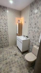 a bathroom with a toilet and a sink at Budget overnight- Struma highway in Pernik