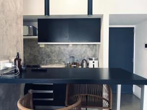 a kitchen with a black counter and two chairs at Luxury apartment in Palermo in Buenos Aires