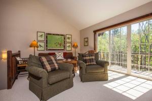 a living room with two chairs and a large window at Whiteface Mtn. Winter Adventure Getaway in Wilmington