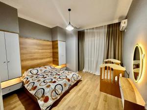 a bedroom with a large bed and a mirror at Your home Fier in Fier