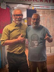 two men standing next to each other in a store at MOSSESS Group Of HouseBoats in Srinagar