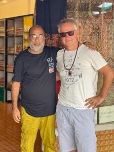 two men standing next to each other in a room at Gulbahaar Group Of HouseBoats in Srinagar