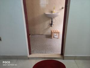 a small bathroom with a sink and a sink at Redrose Service Apartment in Kannur