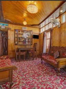 a living room with a couch and a table at Gulbahaar Group Of HouseBoats in Srinagar