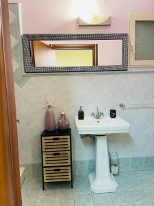 a bathroom with a sink and a mirror at Accogliente Appartamento Spazioso in Grosseto