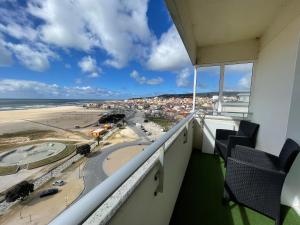 a balcony with two chairs and a view of the beach at MIRASOL 10 in Figueira da Foz