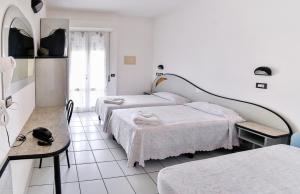 Postel nebo postele na pokoji v ubytování Hotel Rondinella