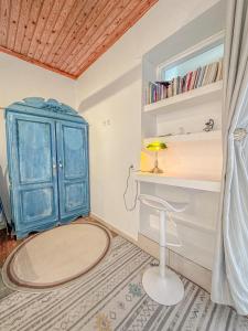 a room with a blue cabinet and a stool at Mountain Bliss Guesthouse 1 next to Sougia in Agrilés
