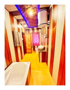 a bathroom with a tub and a sink at Gulbahaar Group Of HouseBoats in Srinagar