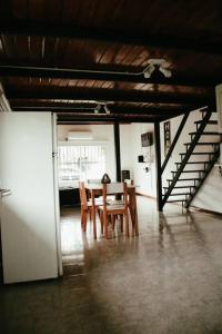 ein Esszimmer mit einem Tisch, Stühlen und einer Treppe in der Unterkunft Casa Tipo Loft- Tigre Centro in Tigre