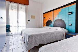Postel nebo postele na pokoji v ubytování Hotel Rondinella