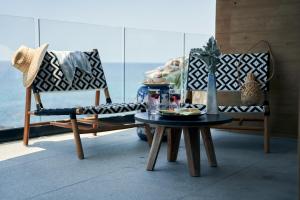 a room with two chairs and a coffee table at Hotel Basalto in Punta Mita