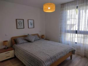 a bedroom with a bed and a large window at Happy Uptown 13 in Funchal