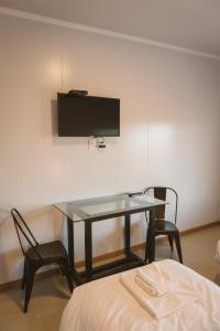 a room with a table and two chairs and a tv at HOTEL CONCHILLAS in Conchillas +9 photos