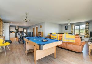 a living room with a ping pong table in it at Breconview Lodge in Coelbren