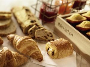 a group of breads and pastries on a table at ibis Bordeaux Centre - Gare Saint-Jean in Bordeaux