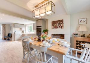 a kitchen and dining room with a table and chairs at The Firs in Brundall